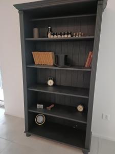a black cabinet with shelves in a room at Paradise 31 in Paradiso +4 photos