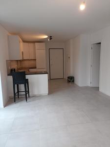 an empty living room with a table and a kitchen at Paradise 31 in Paradiso