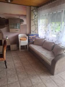 a living room with a couch and a table at Juci Home Apartman in Vonyarcvashegy
