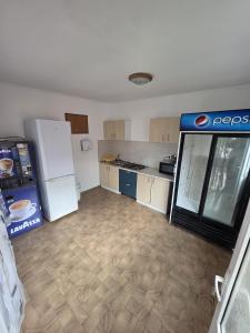 a kitchen with a pepsi refrigerator in a room at Casa Ana Maria in Vama Veche +23 photos