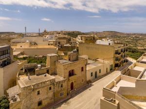 an aerial view of a city with buildings at Ta' Kullarina Farmhouse in Żebbuġ