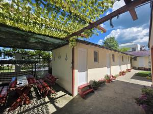 a patio with a table and chairs and a building at Casa Ana Maria in Vama Veche