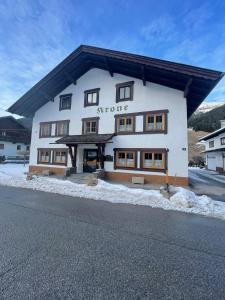 a large white building with a sign on it at Haus Krone in Lähn