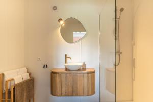 a bathroom with a sink and a mirror at Tiny House XL | 2 persons in Gasselte +38 photos