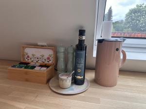 a table with a bottle and a box of cosmetics at Old Town Loft Middelfart in Middelfart