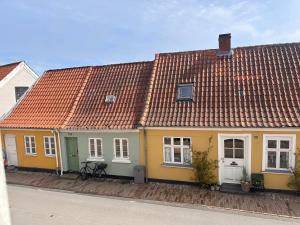 a row of houses with orange roofs at Old Town Loft Middelfart in Middelfart