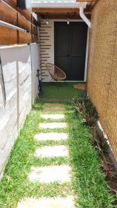 a walkway leading to a patio with a chair at Studio Maison à Saint-Denis in Saint-Denis