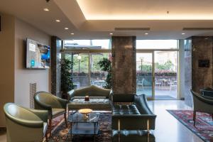 a lobby with a couch and chairs and a table at Sangallo Palace in Perugia