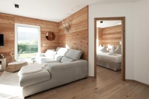 a living room with a couch and a bedroom at Chasseral Sky Dome in Twann