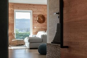 a living room with a couch and a window at Chasseral Sky Dome in Twann +28 photos