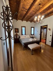a bedroom with a bed and a chandelier at Villa Belvedere - The perfect Villa in Katakolo in Agios Andreas +88 photos