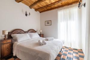 a bedroom with a large bed with shoes on it at Incanto del Lago Country House in Faggeto Lario 