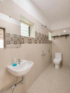 a bathroom with a sink and a toilet at Bhumika by evaddo stays in Mandrem +53 photos