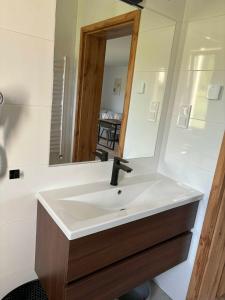 a bathroom with a sink and a mirror at Biała Ostoja 517-539-965 in Berezka