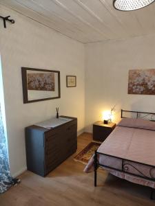 a bedroom with a bed and a dresser at Casa Yos in Vallerano