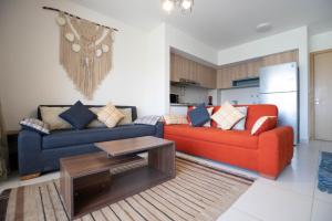 a living room with two couches and a table at Marina Marassi in El Alamein +10 photos