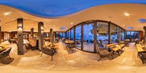 a restaurant with tables and chairs and windows at Boutiquehotel zur Winzerstube - Adults Only in Hagnau