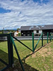 a fence with solar panels on a building at Chalet an der Sonne nahe Klopeiner See und Petzen Bergbahn in Sankt Stefan +7 photos