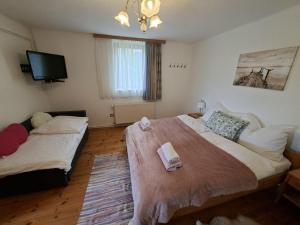 a bedroom with a large bed and a flat screen tv at Chalet an der Sonne nahe Klopeiner See und Petzen Bergbahn in Sankt Stefan