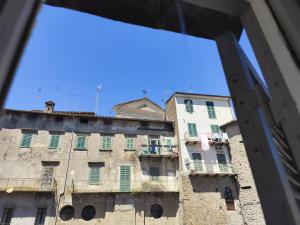 a view of an old building from a window at Casa Yos in Vallerano