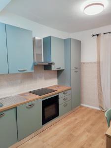 a kitchen with blue cabinets and a stove top oven at Casa Yos in Vallerano