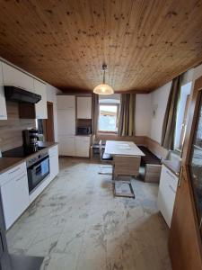 a kitchen with a table in the middle of it at Chalet an der Sonne nahe Klopeiner See und Petzen Bergbahn in Sankt Stefan
