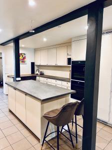 a kitchen with a counter and a chair in it at Walteri guest house in Tetele