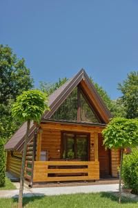 a log cabin with a gambrel roof at Sicevacka Bajka log cabin in a nature park in Niš