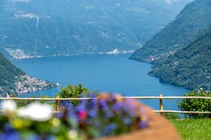 a view of a blue lake in the mountains at Incanto del Lago Country House in Faggeto Lario 