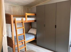 a bunk bed room with two bunk beds and a ladder at Shells & Pines in Jūrmala