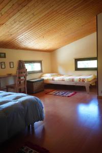 a bedroom with two beds and a desk in a room at Tenuta Seredipà in Castellammare del Golfo