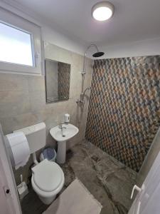 a bathroom with a toilet and a sink at Casa Ana Maria in Vama Veche