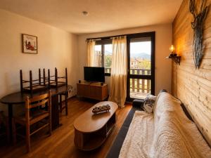 a living room with a couch and a table at Cozy studio balcon et parking in Font-Romeu