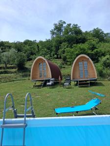 two dome shaped tents with a pool in the grass at Ca' della Civetta in Gavedo