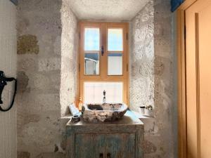 a bathroom with a stone sink and a window at Marge Hotel Adult Only 12 plus in Ilıca