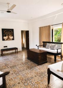 a living room with two beds and a fireplace at Bhumika by evaddo stays in Mandrem