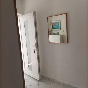 a hallway with a mirror and a picture on the wall at B&B Sveti Petar in Sveti Petar