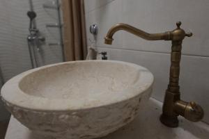 a marble sink with a faucet in a bathroom at Apartment Jugo in Preko