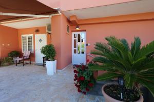 a front porch of a house with plants and flowers at Apartment Jugo in Preko