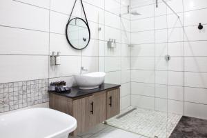 a white bathroom with a sink and a mirror at Guest at 58 in Lydenburg +24 photos