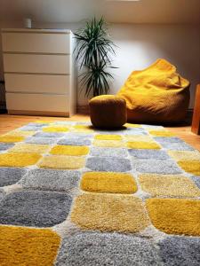 a yellow and grey rug on the floor in a room at Apartmán Kunratice 2 in Kunratice