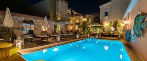 a swimming pool in a hotel at night at Marge Hotel Adult Only 12 plus in Ilıca