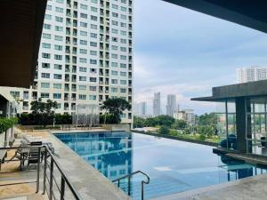 a swimming pool with a view of a tall building at lumpini naklua wongamat in North Pattaya