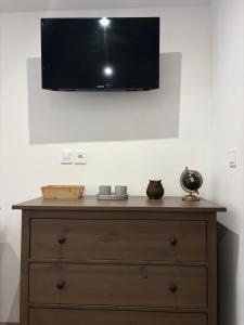 a tv on a wall above a dresser at Apartmán Kunratice in Kunratice +15 photos