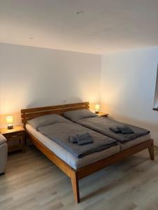 a bedroom with a bed with two lamps on it at Apartmán Kunratice in Kunratice