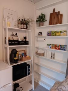 a room with white shelves and a tv at Studio Leilighet in Moss