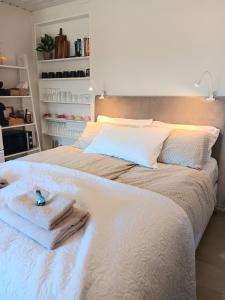 a bedroom with a white bed with towels on it at Studio Leilighet in Moss
