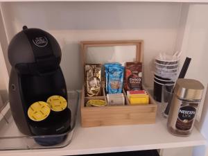 a coffee maker sitting on a shelf next to a wooden box at Studio Leilighet in Moss +8 photos