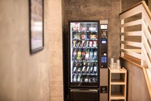 a vending machine filled with lots of soda cans at Bundt's Hotel & Gartenrestaurant in Hamburg