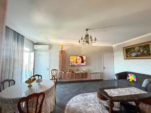 a living room with a table and a couch at kobuleti Apartment in Kobuleti